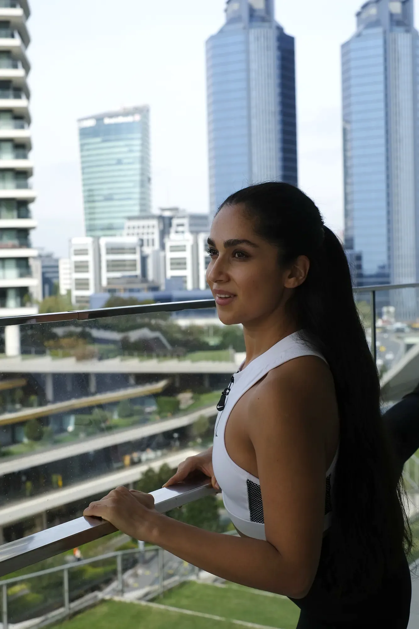 Sepideh, founder of Sépilates, on a balcony